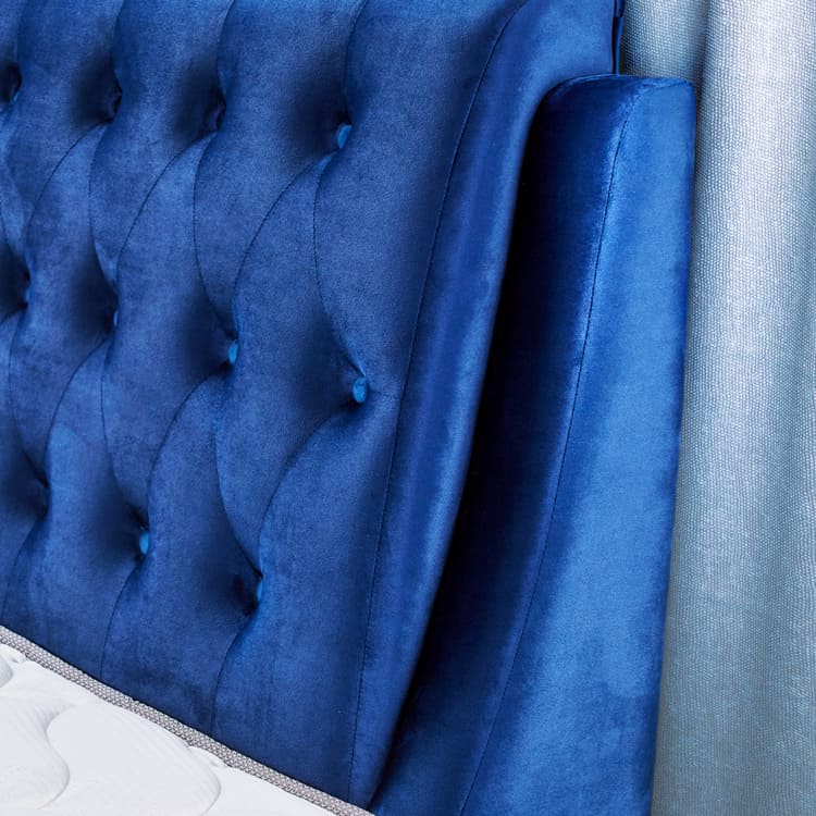 Dark blue tufted headboard close-up