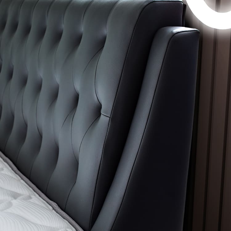 Dark grey tufted headboard close-up
